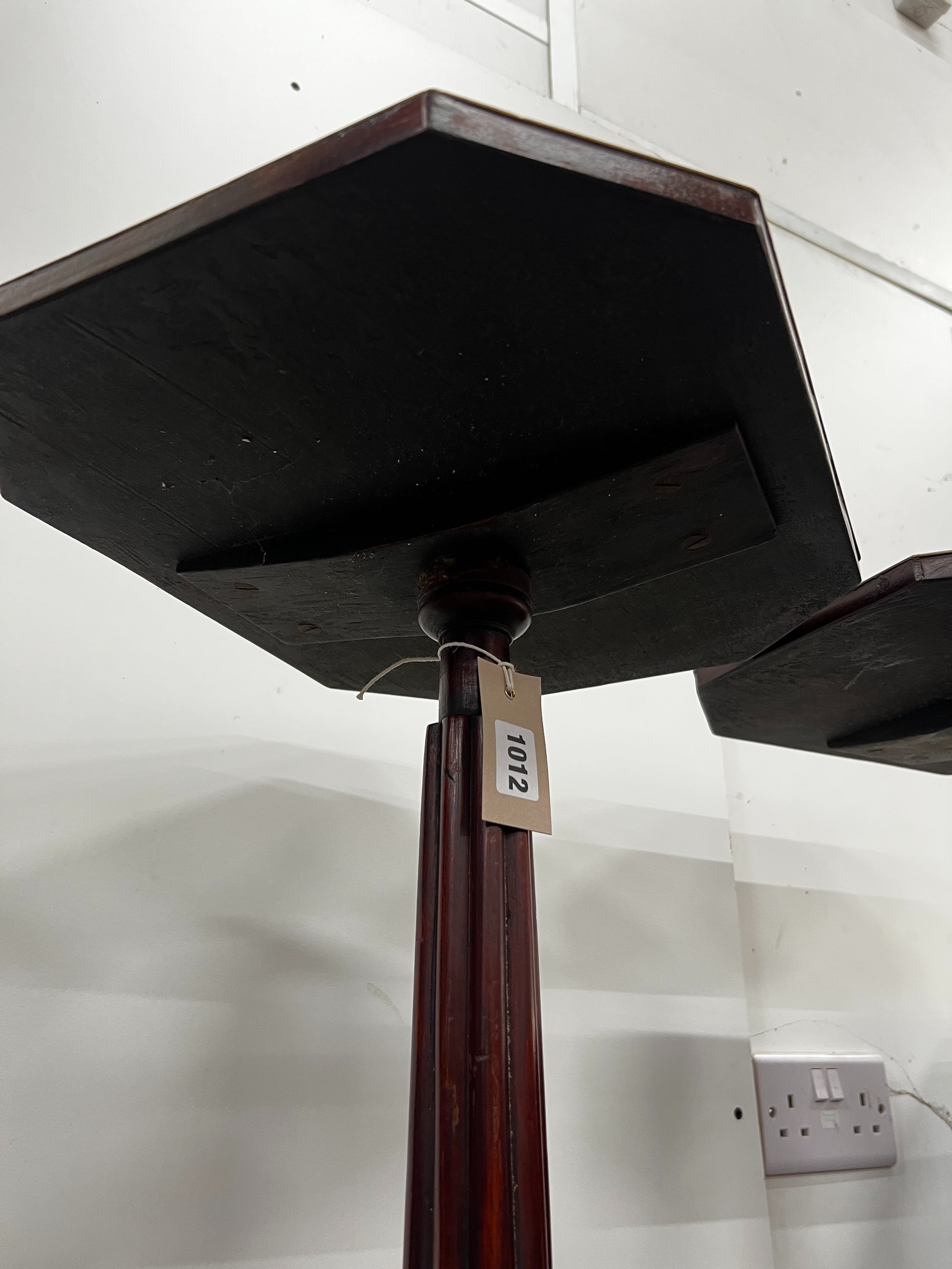 A pair of Regency style brass mounted mahogany octagonal top tripod tables, width 39cm, depth 32cm, height 71cm